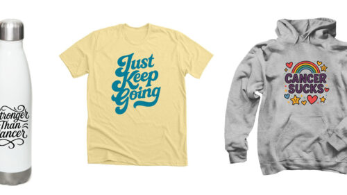 Three cancer support fundraiser items: a white stainless-steel water bottle printed with ‘Stronger Than Cancer,’ a soft yellow T-shirt reading ‘Just Keep Going,’ and a gray pullover hoodie featuring a colorful rainbow and ‘Cancer Sucks’ graphic.