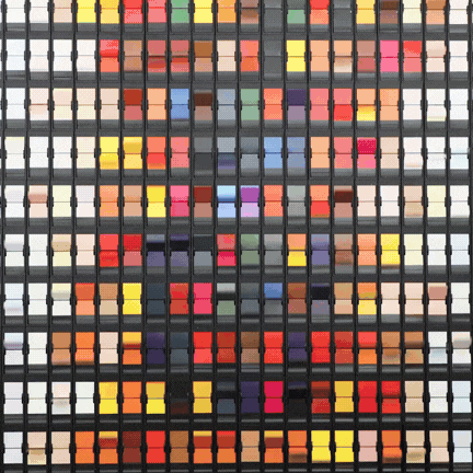 ChromaFlap split-flap display by Oat Foundry featuring a grid of colorful mechanical flaps arranged in rows and columns within a black frame system