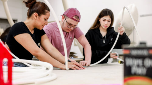 Students in Dunwoody College of Technology’s Experiential Graphic Design Degree program collaborate on a hands-on fabrication project in a design studio.