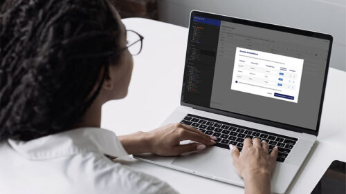 Person reviewing multilingual signage translations in SignAgent’s AI translation tool on a laptop.